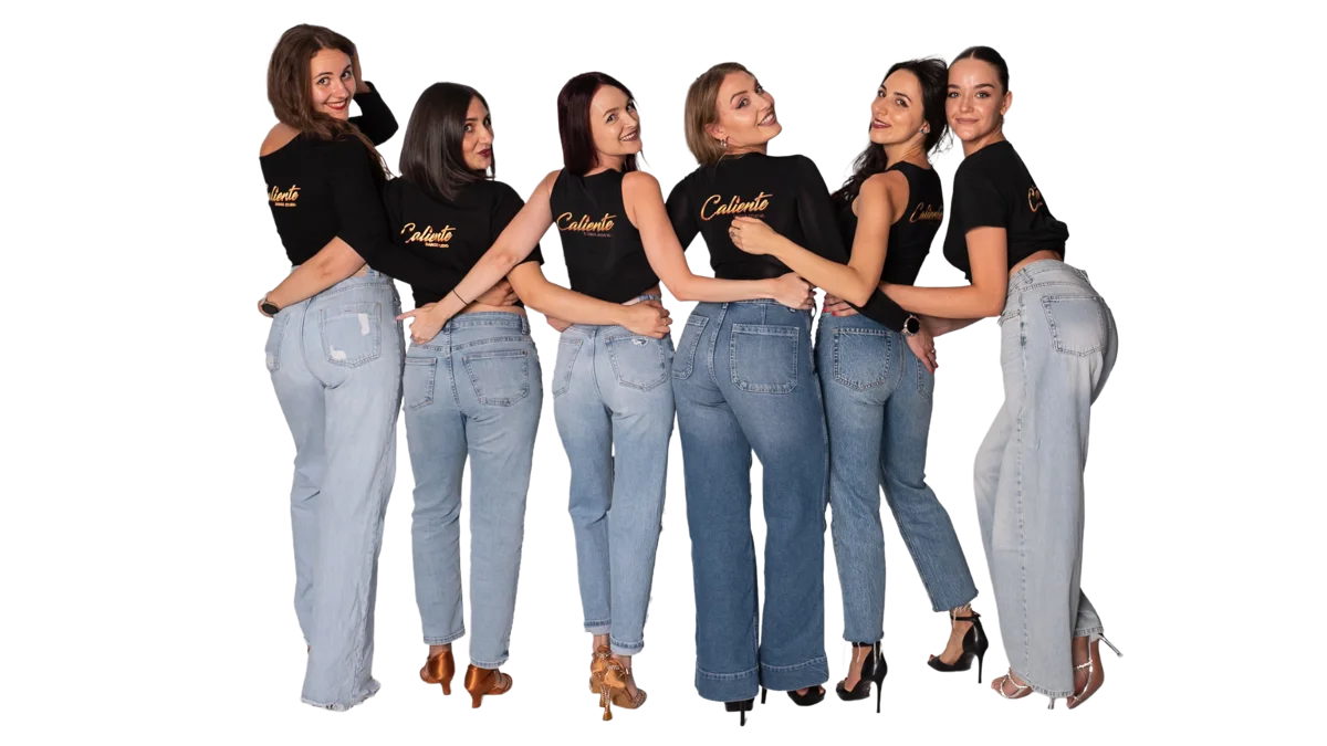 Several young women smiling and participating in a dance class.