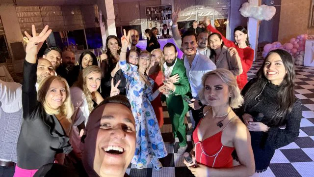 A candid shot of people enjoying an event, possibly a wedding or party.